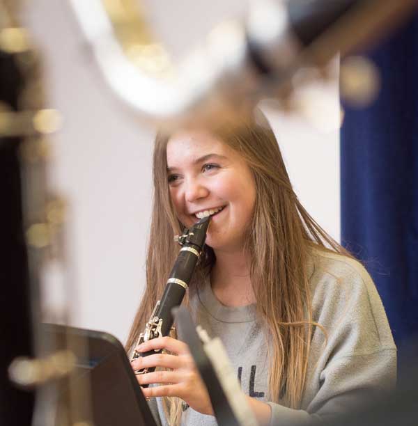 Teenage girl playing instrument